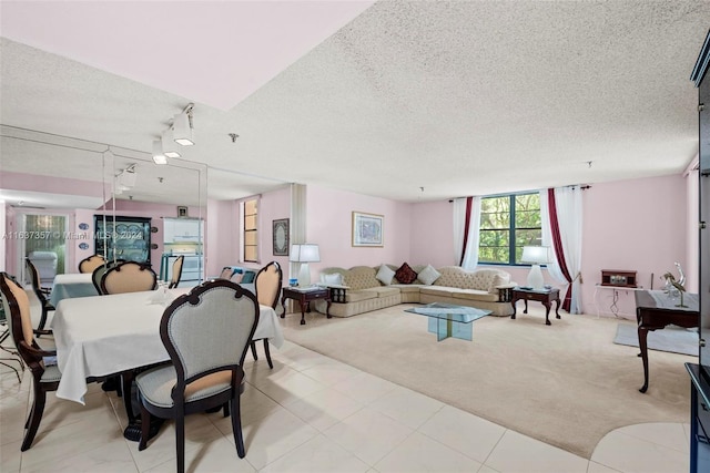 tiled dining room with rail lighting and a textured ceiling