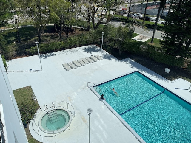 view of pool with a patio and a community hot tub