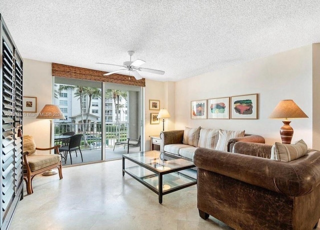 living room featuring a textured ceiling, light tile patterned flooring, and ceiling fan