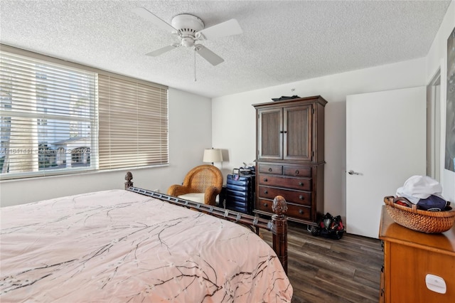 bedroom featuring dark wood-style floors, a textured ceiling, and a ceiling fan