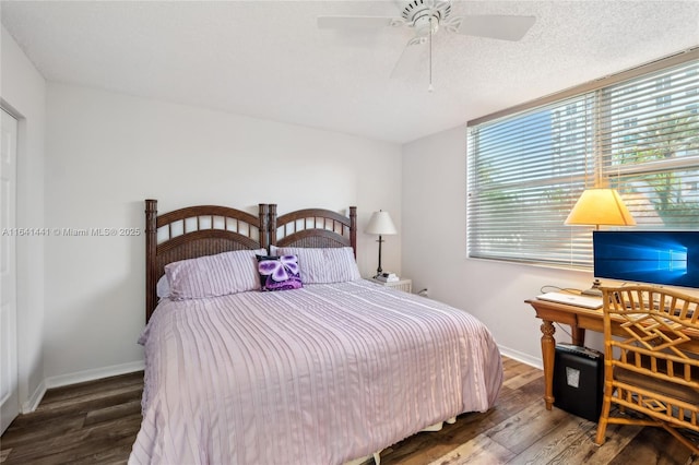 bedroom with ceiling fan, a textured ceiling, baseboards, and wood finished floors