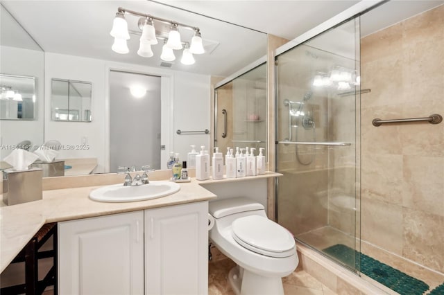 full bath with a stall shower, vanity, and toilet