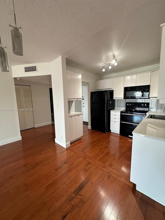 kitchen featuring black appliances, sink, white cabinets, and dark hardwood / wood-style floors