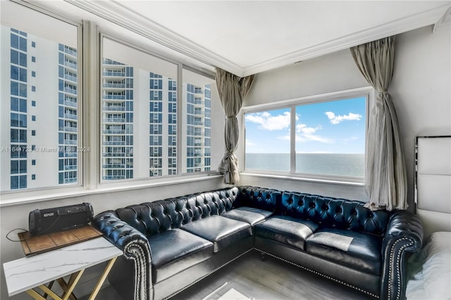 living room featuring ornamental molding, a water view, and hardwood / wood-style flooring