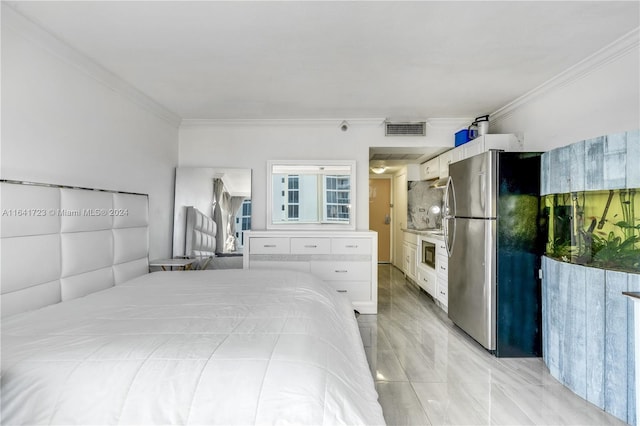 bedroom featuring freestanding refrigerator, visible vents, and crown molding