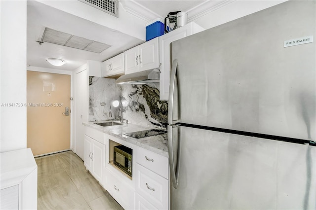 kitchen featuring black appliances, wall chimney exhaust hood, light hardwood / wood-style floors, backsplash, and sink