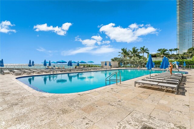 view of swimming pool featuring a patio area