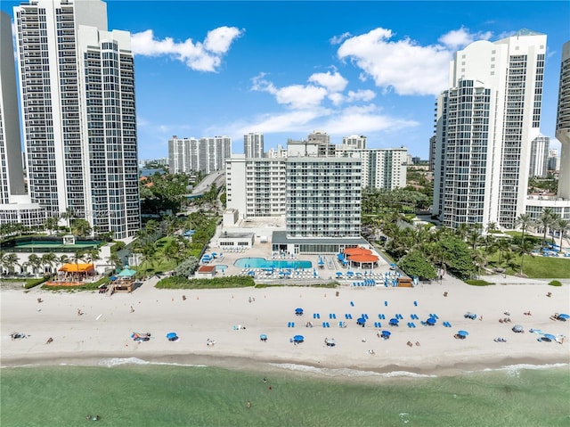 bird's eye view with a water view, a view of city, and a beach view