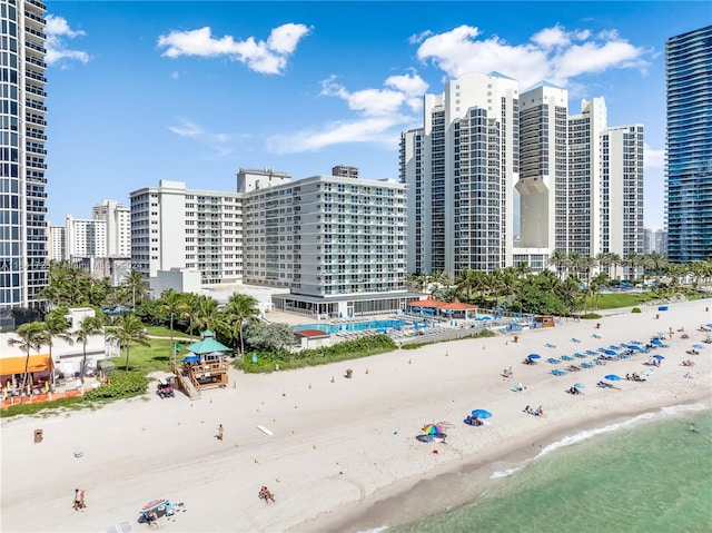 drone / aerial view featuring a water view and a view of the beach