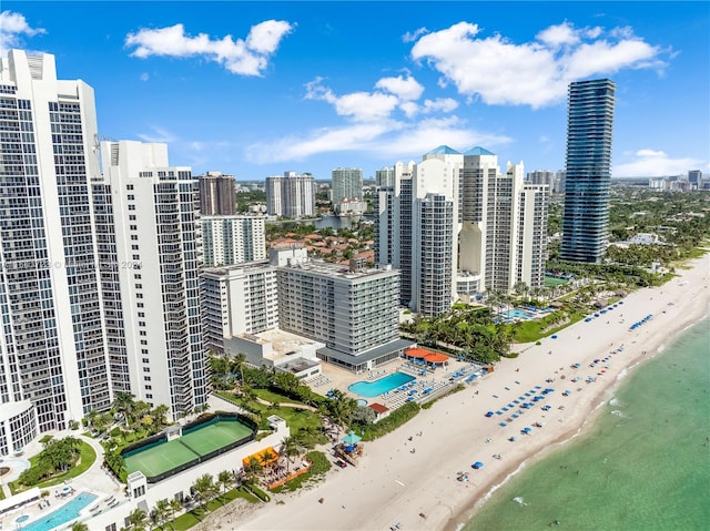 aerial view with a water view and a beach view