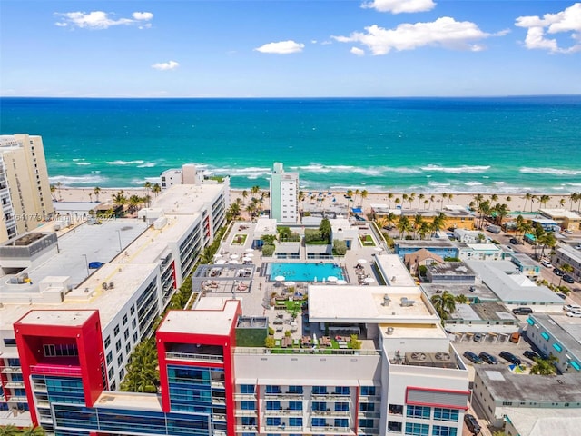 birds eye view of property featuring a water view and a beach view