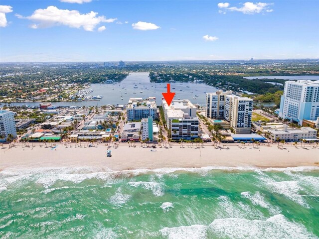 aerial view with a water view and a view of the beach