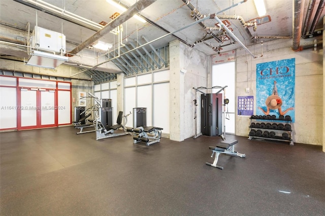 exercise room featuring a high ceiling