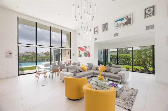 living room with light tile patterned flooring and a towering ceiling