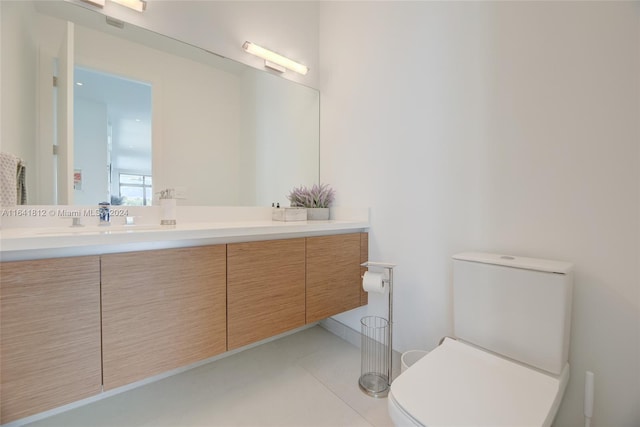 bathroom featuring tile patterned floors, vanity, and toilet