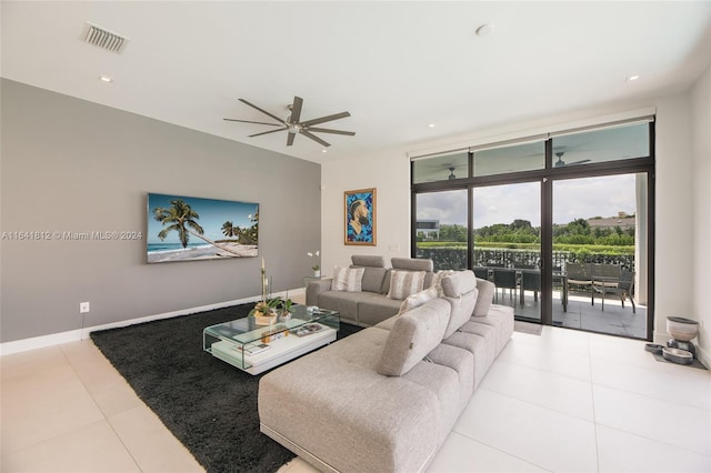 tiled living room featuring a wall of windows and ceiling fan