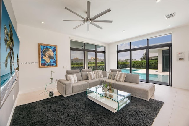 tiled living room featuring a wall of windows and ceiling fan