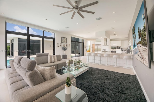 tiled living room featuring ceiling fan