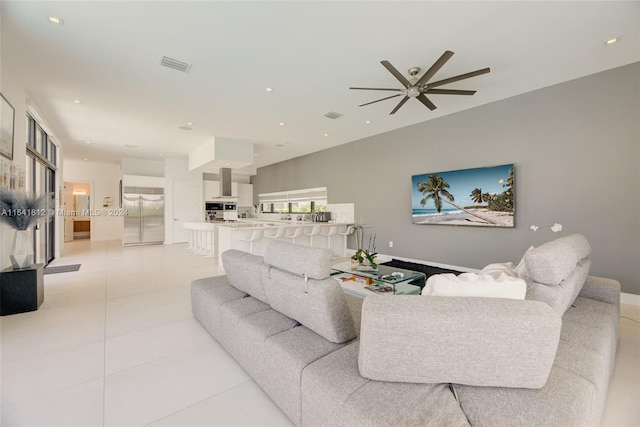 tiled living room featuring ceiling fan