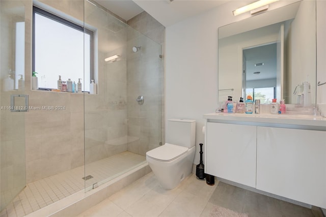 bathroom featuring toilet, walk in shower, tile patterned flooring, and vanity