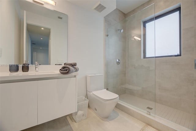 bathroom with vanity, toilet, tile patterned floors, and a shower with shower door