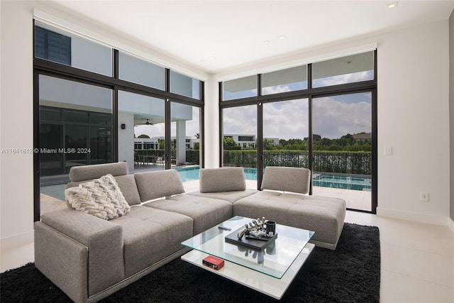16768 Natures Way, Weston, FL 33326 - living room featuring a water view, expansive windows, light tile patterned floors, and baseboards