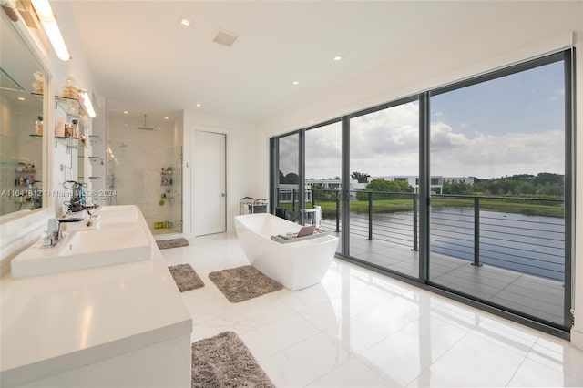 16768 Natures Way, Weston, FL 33326 - full bath featuring a shower stall, a water view, a soaking tub, double vanity, and recessed lighting