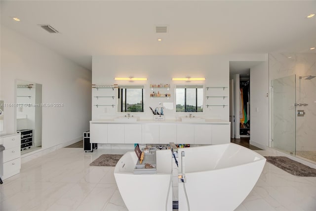 bathroom featuring shower with separate bathtub, tile patterned flooring, and vanity