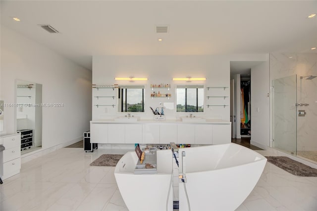 16768 Natures Way, Weston, FL 33326 - full bathroom with a freestanding tub, a marble finish shower, double vanity, marble tiled floors, and recessed lighting