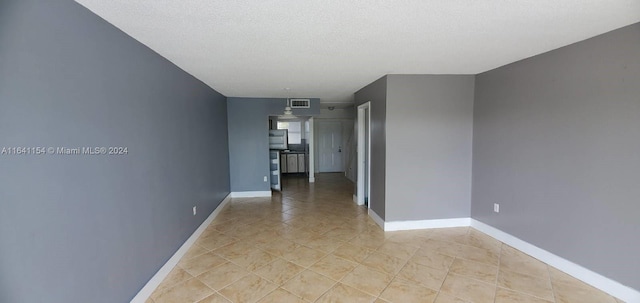 hall with a textured ceiling