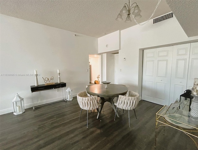 dining area featuring a textured ceiling, dark wood-style flooring, visible vents, and baseboards