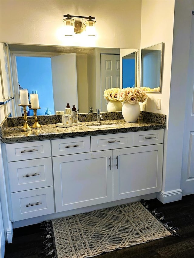 bathroom with vanity and baseboards