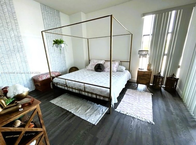 bedroom with wood finished floors and baseboards