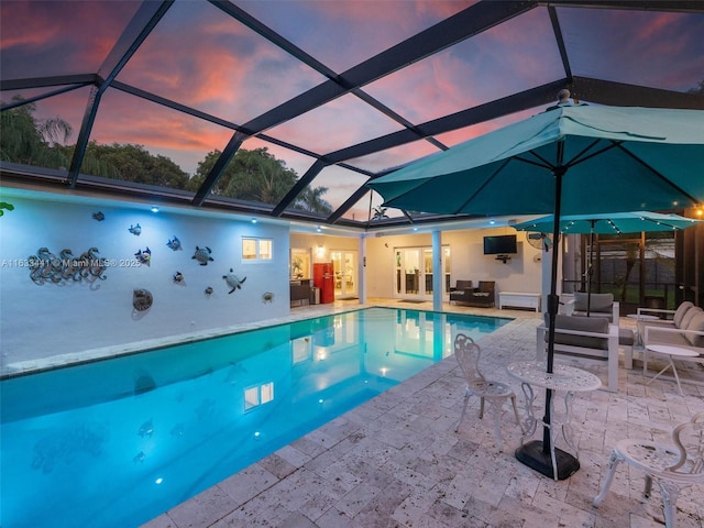 pool featuring a patio area, outdoor lounge area, and a lanai