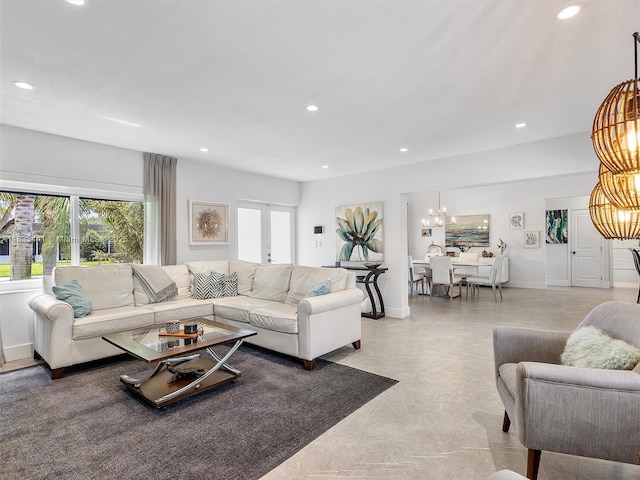 living room with baseboards, recessed lighting, and a notable chandelier