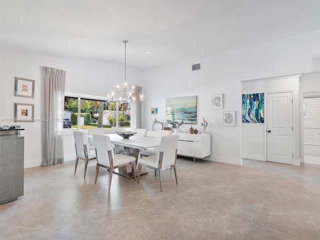 dining area with lofted ceiling, an inviting chandelier, baseboards, and visible vents