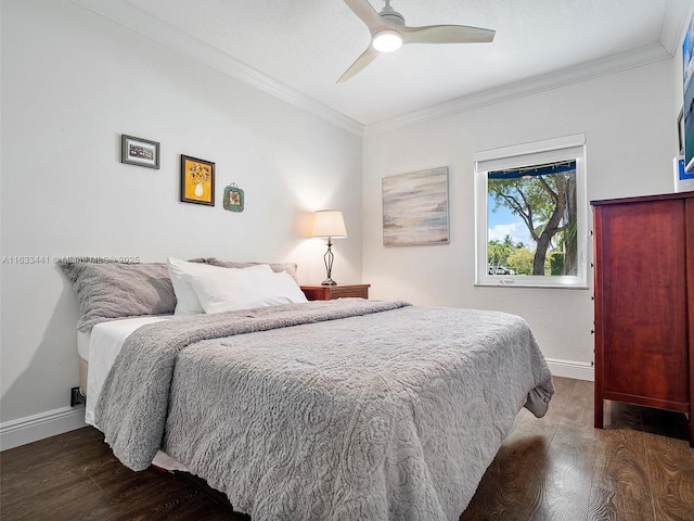 bedroom featuring baseboards, ornamental molding, ceiling fan, and dark wood-type flooring