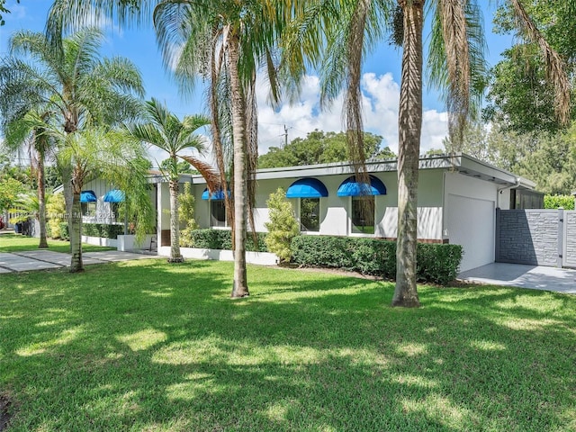 view of front of house with a front yard and stucco siding