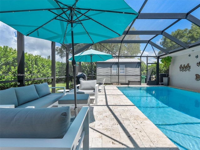 outdoor pool featuring a lanai, outdoor lounge area, a patio, and an outdoor structure