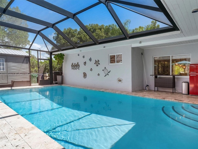 pool with glass enclosure, an outbuilding, and a patio