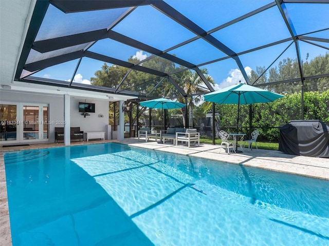 outdoor pool featuring a patio, a lanai, area for grilling, outdoor lounge area, and french doors