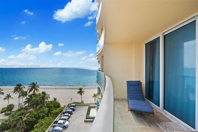 balcony with a water view and a beach view