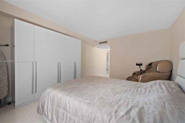 tiled bedroom featuring a closet