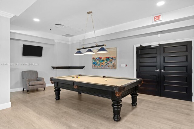 rec room with light hardwood / wood-style floors and billiards