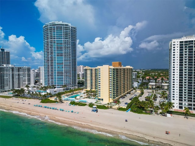 drone / aerial view featuring a water view and a beach view