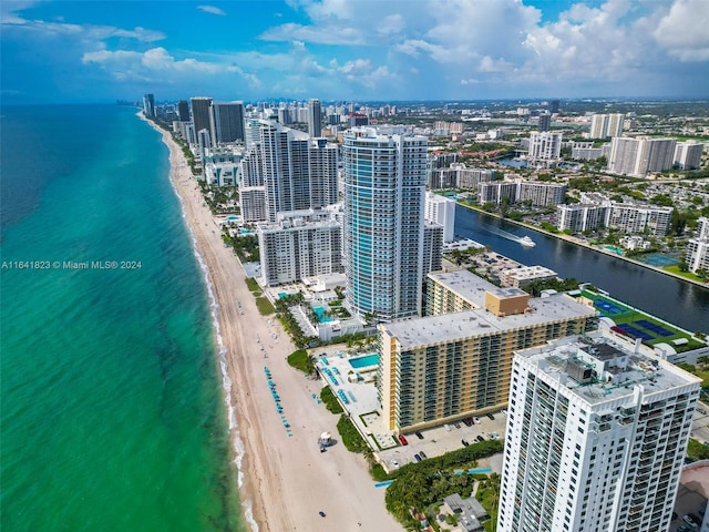 drone / aerial view featuring a water view and a beach view