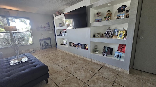 tiled living room with a textured ceiling and built in features