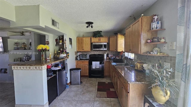 kitchen with light tile patterned flooring, sink, black electric range, and backsplash