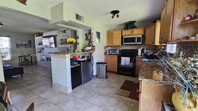 kitchen with tasteful backsplash, a textured ceiling, black range with electric cooktop, and light tile patterned flooring