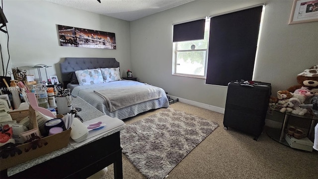 carpeted bedroom featuring a textured ceiling